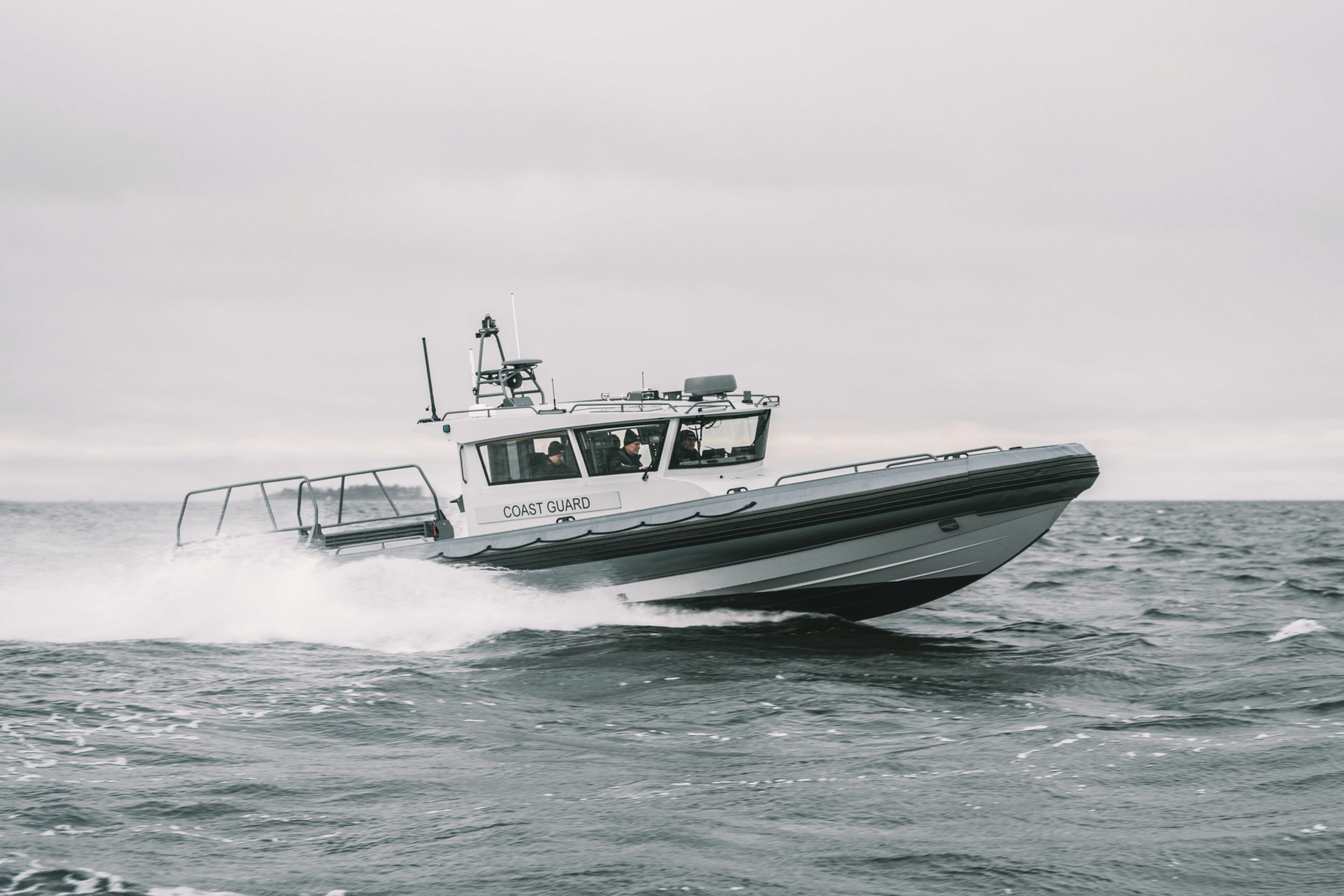 A partol boat Boomeranger C-1300 IB Patrol moving on high speed in the rough sea