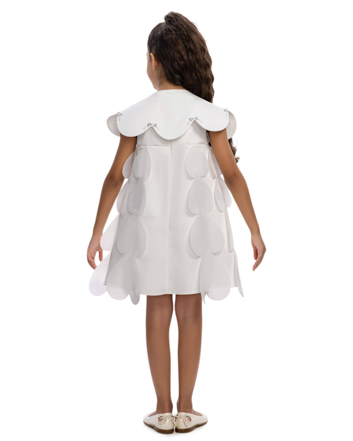 White dress with ruffled collar and cut-out design on a white background