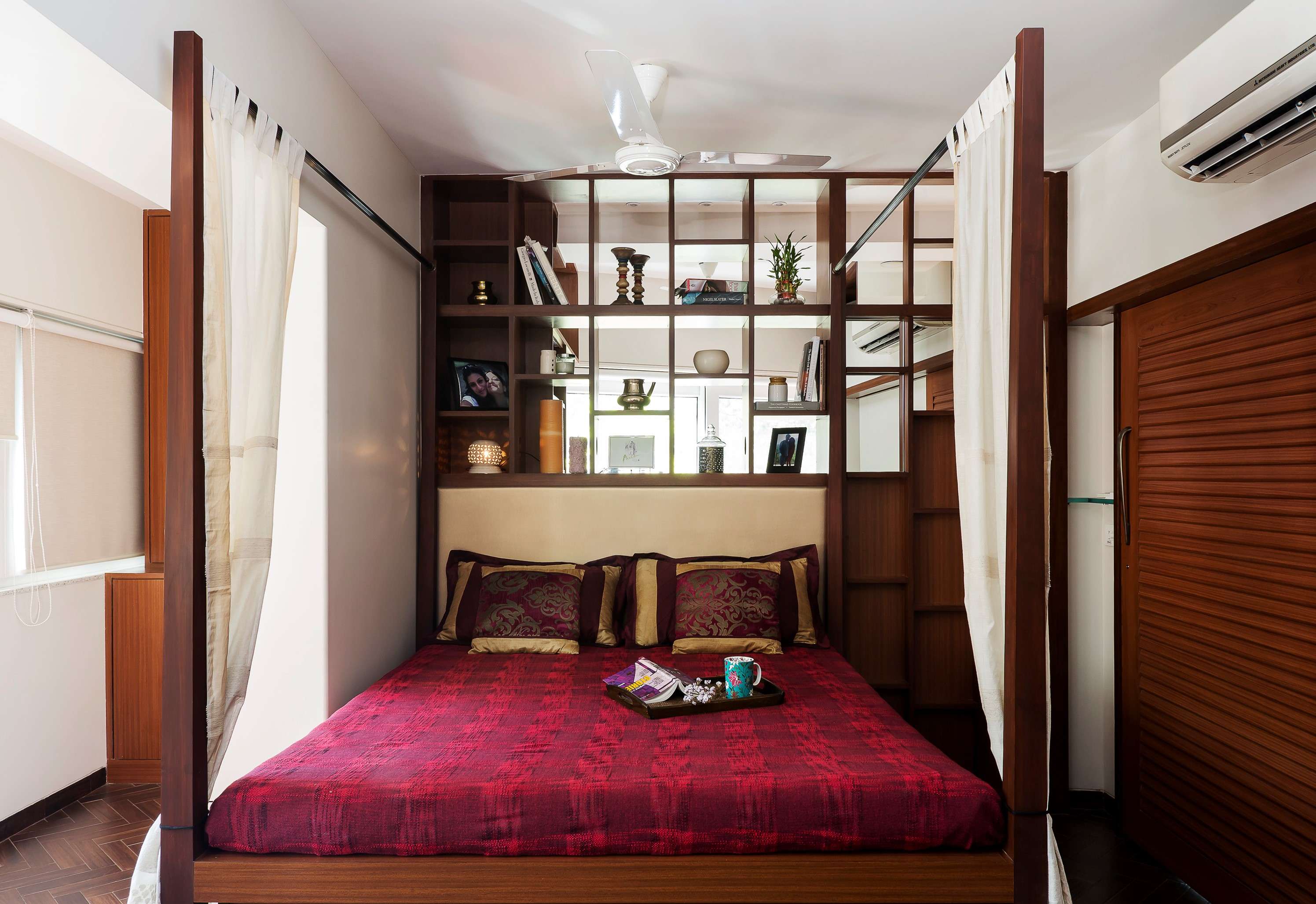 Nature-inspired preschool entrance with sculptural tree partitions and suspended green leaf ceiling panels.