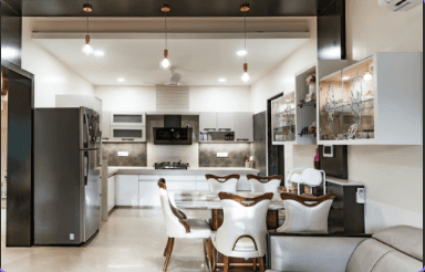 silver pendant lamps turned on above white ceramic bowls