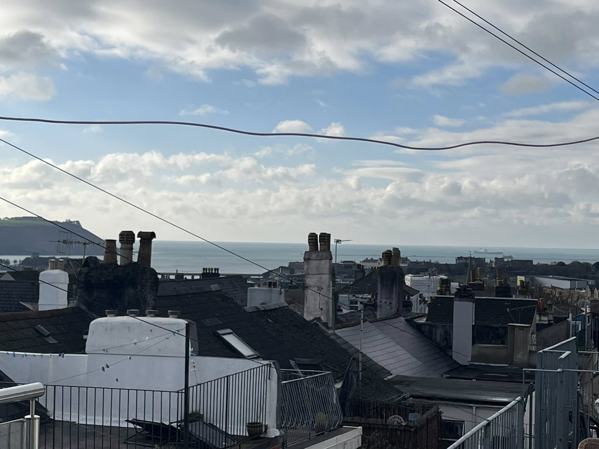 a man in a yellow shirt is working on a roof
