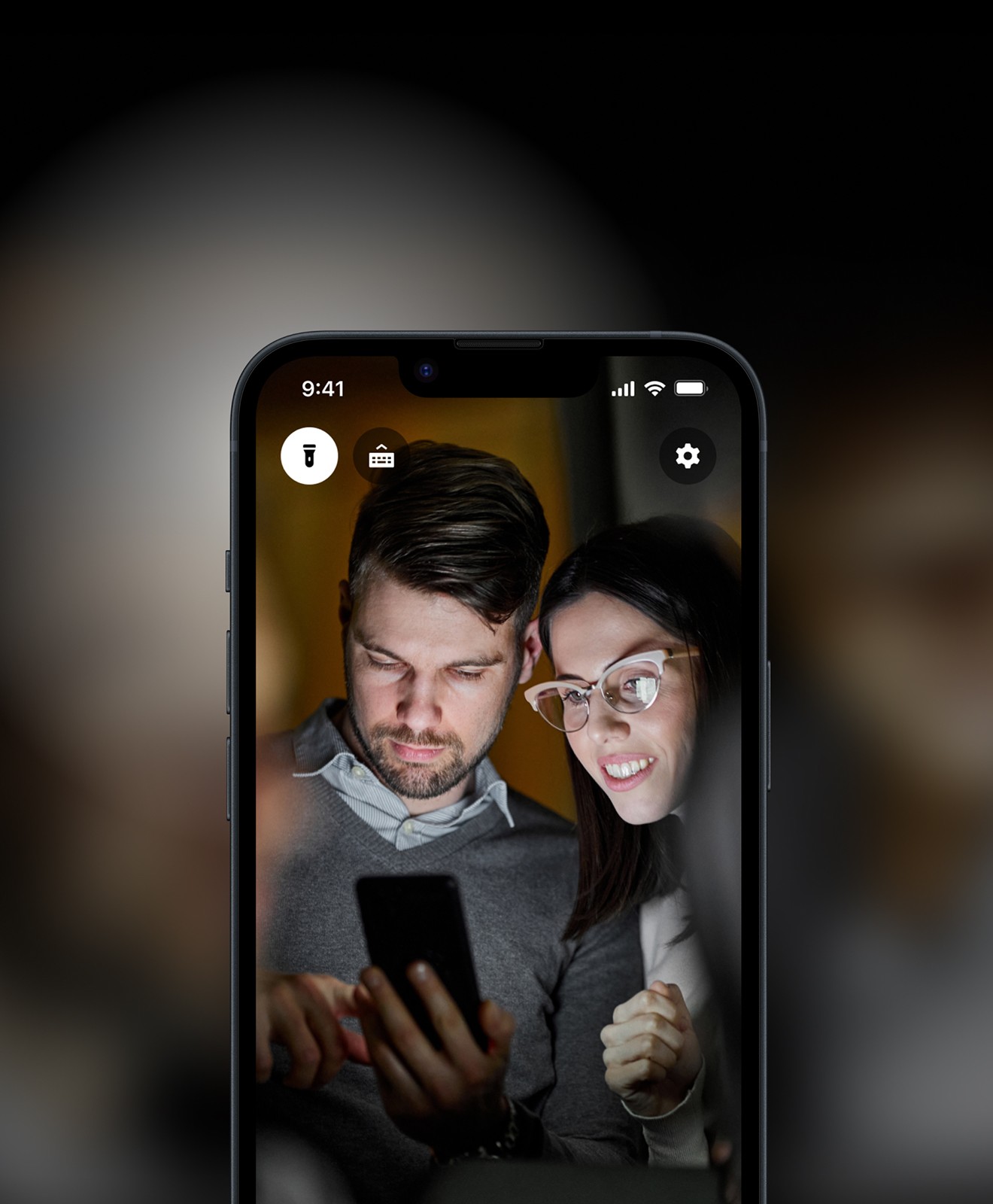 Couple looking for tickets on their phone in dark room
