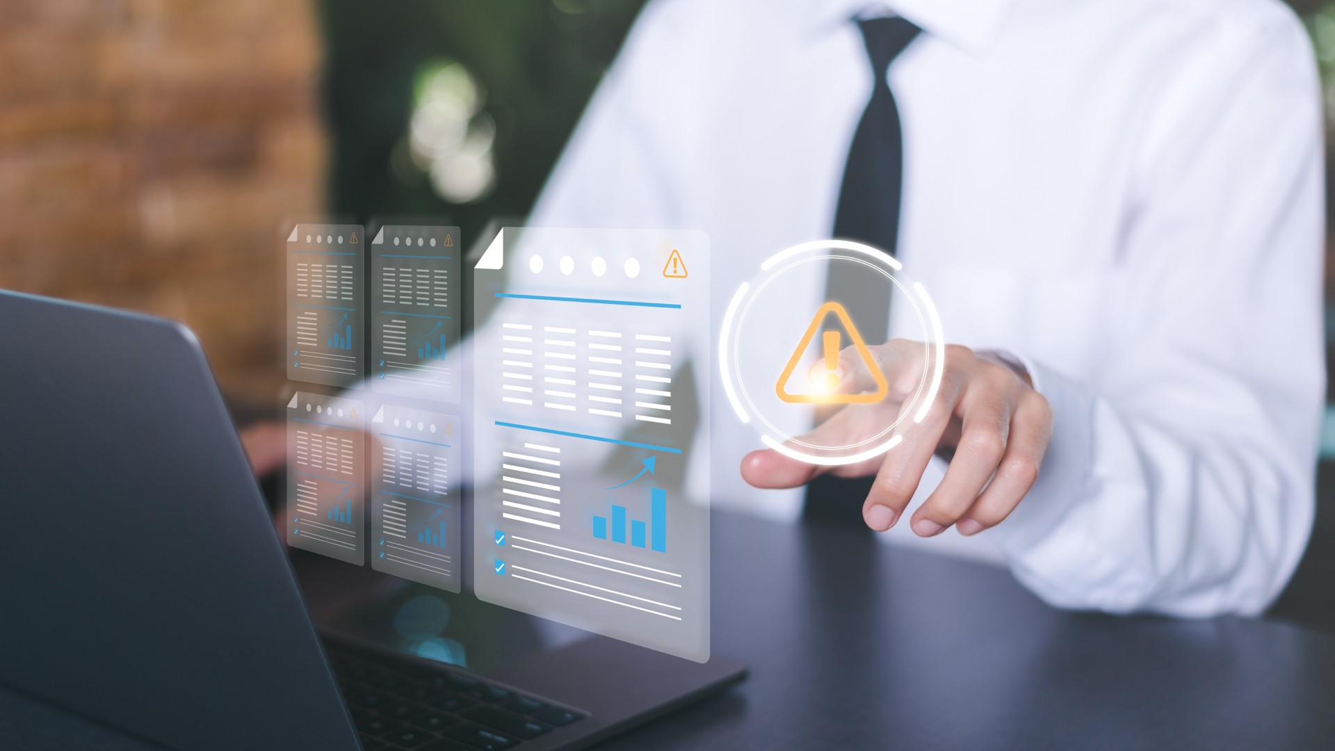 Compliance professional reviewing digital documents with warning indicators on a laptop, representing how sanctions screening works and the role of global sanctions lists in AML compliance.