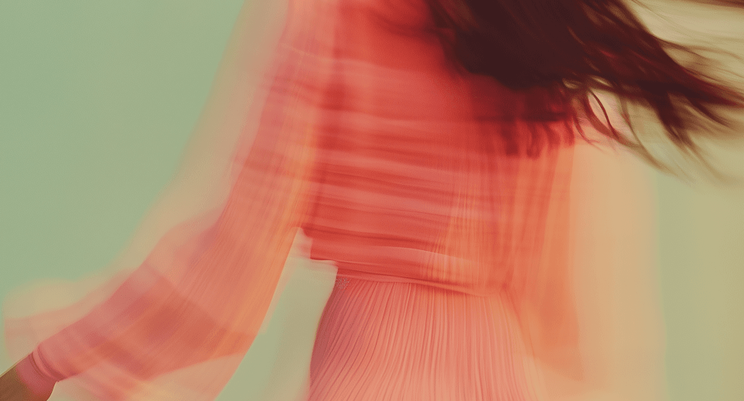 A woman in a pink dress is gracefully walking in mid-air against a clear blue sky.