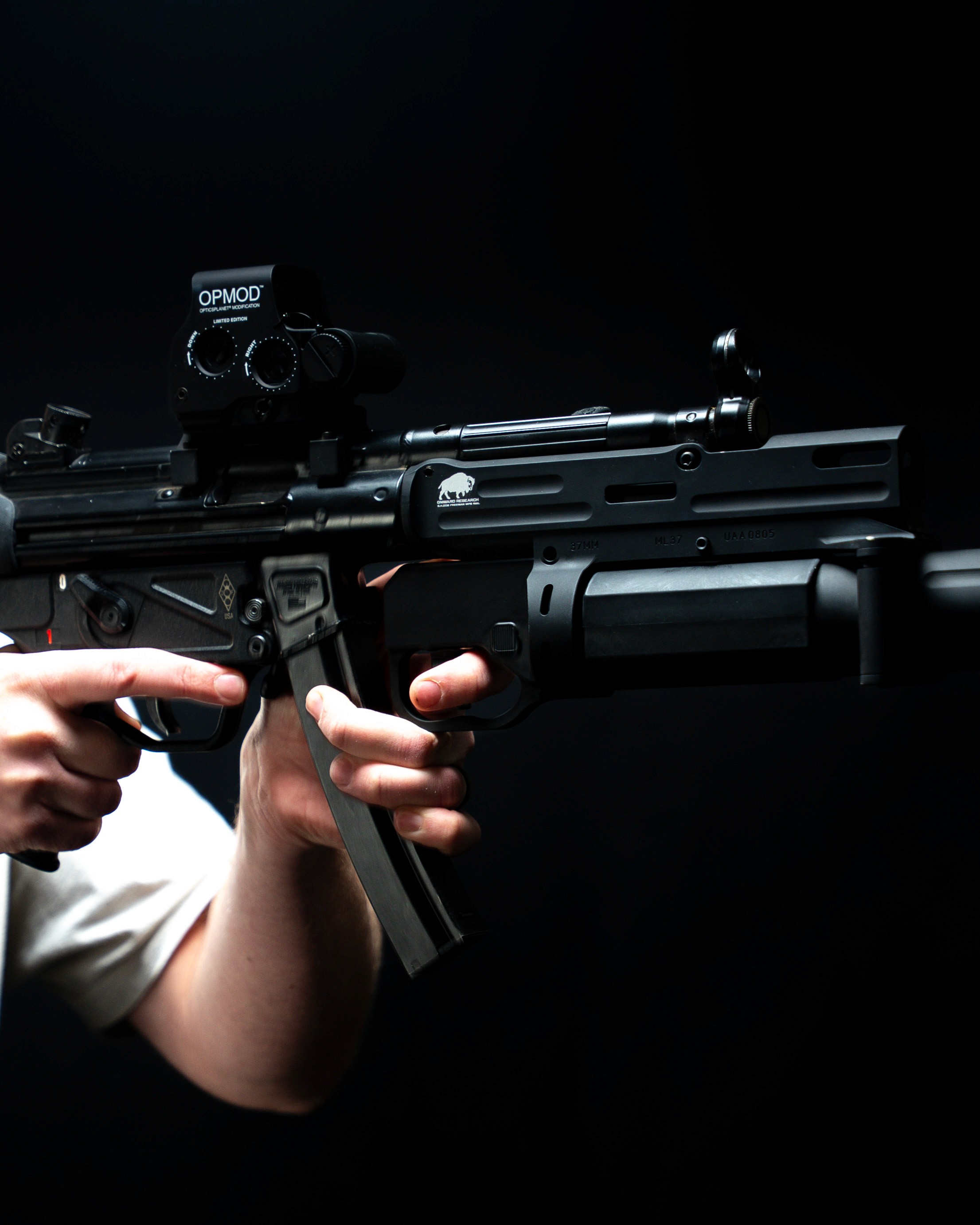 Black and white photo of two people looking at a computer screen with papers on wall
