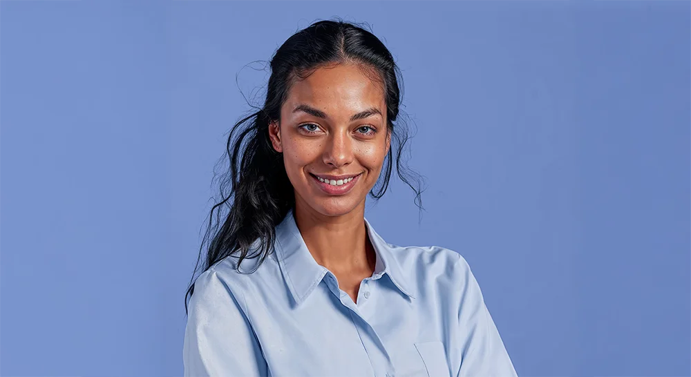 portrait of woman in blue shirt with blue background