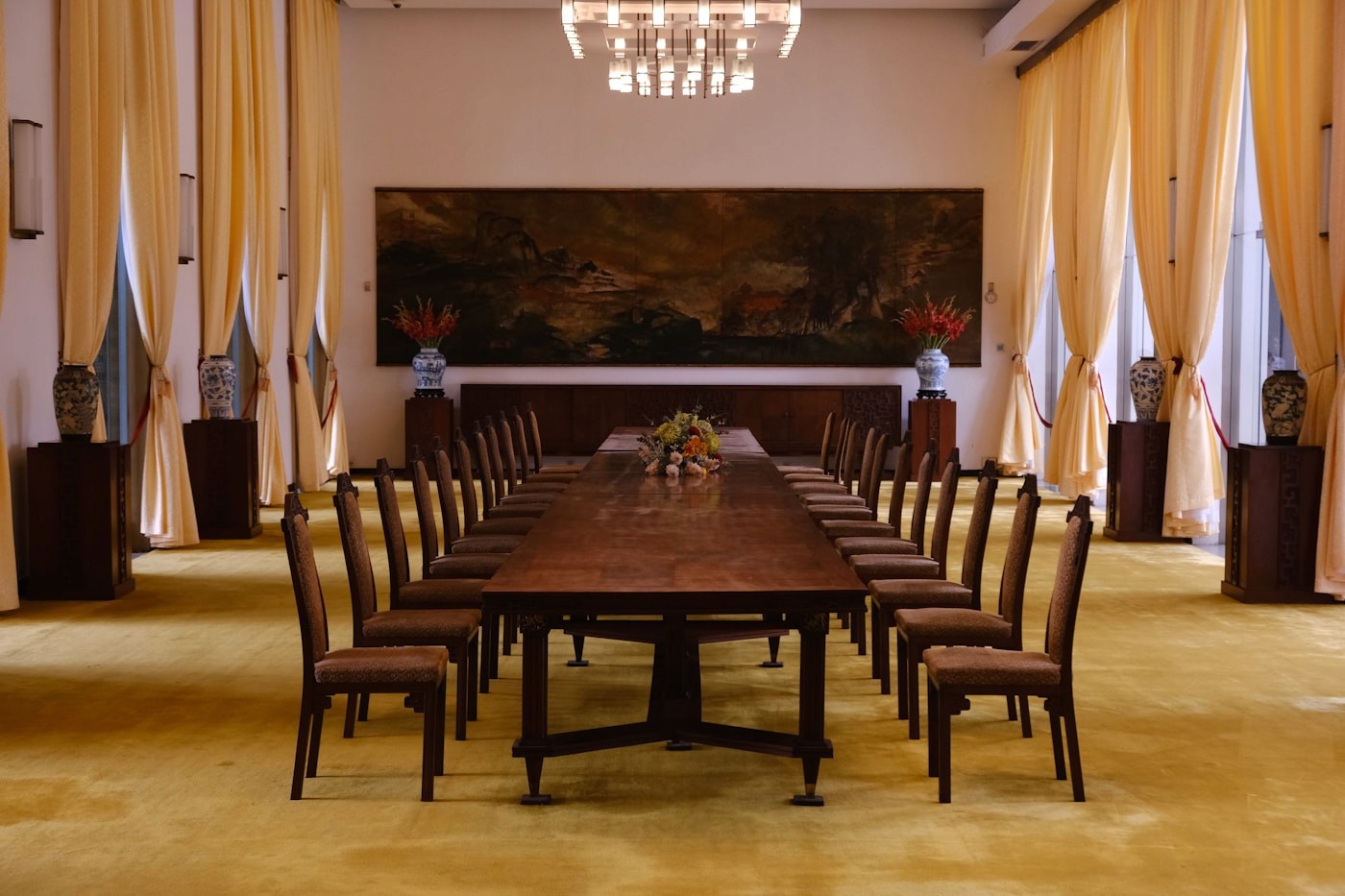A long empty boardroom table lined with chairs