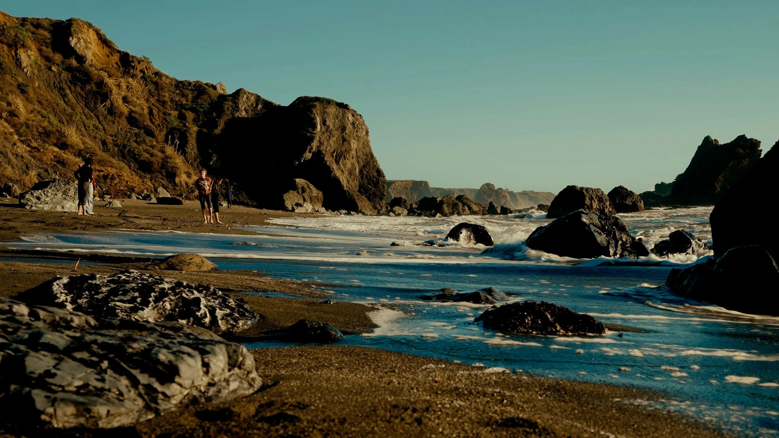 The image features two hands reaching towards each other against a plain background. 