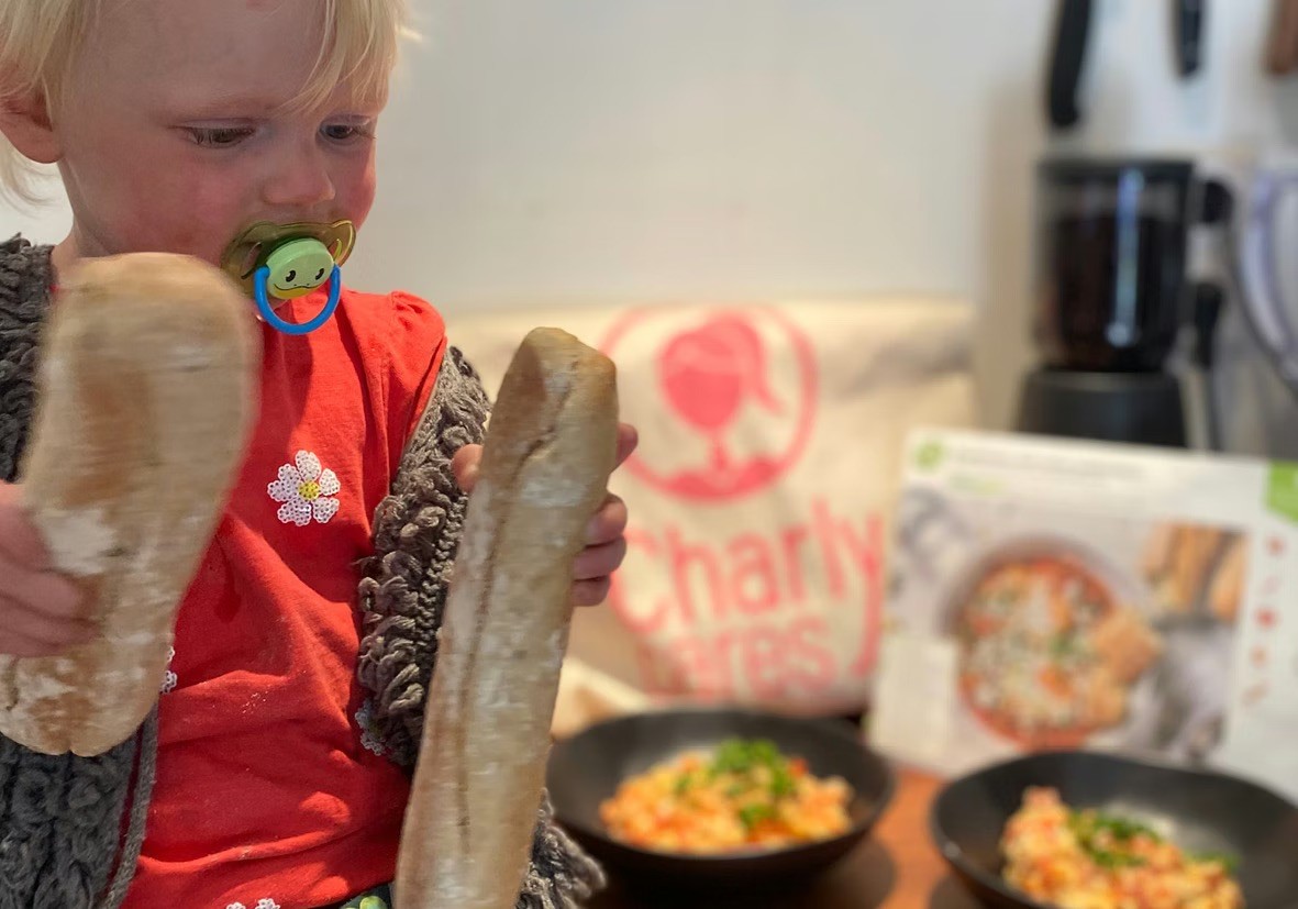 Babysitter and kid cook together