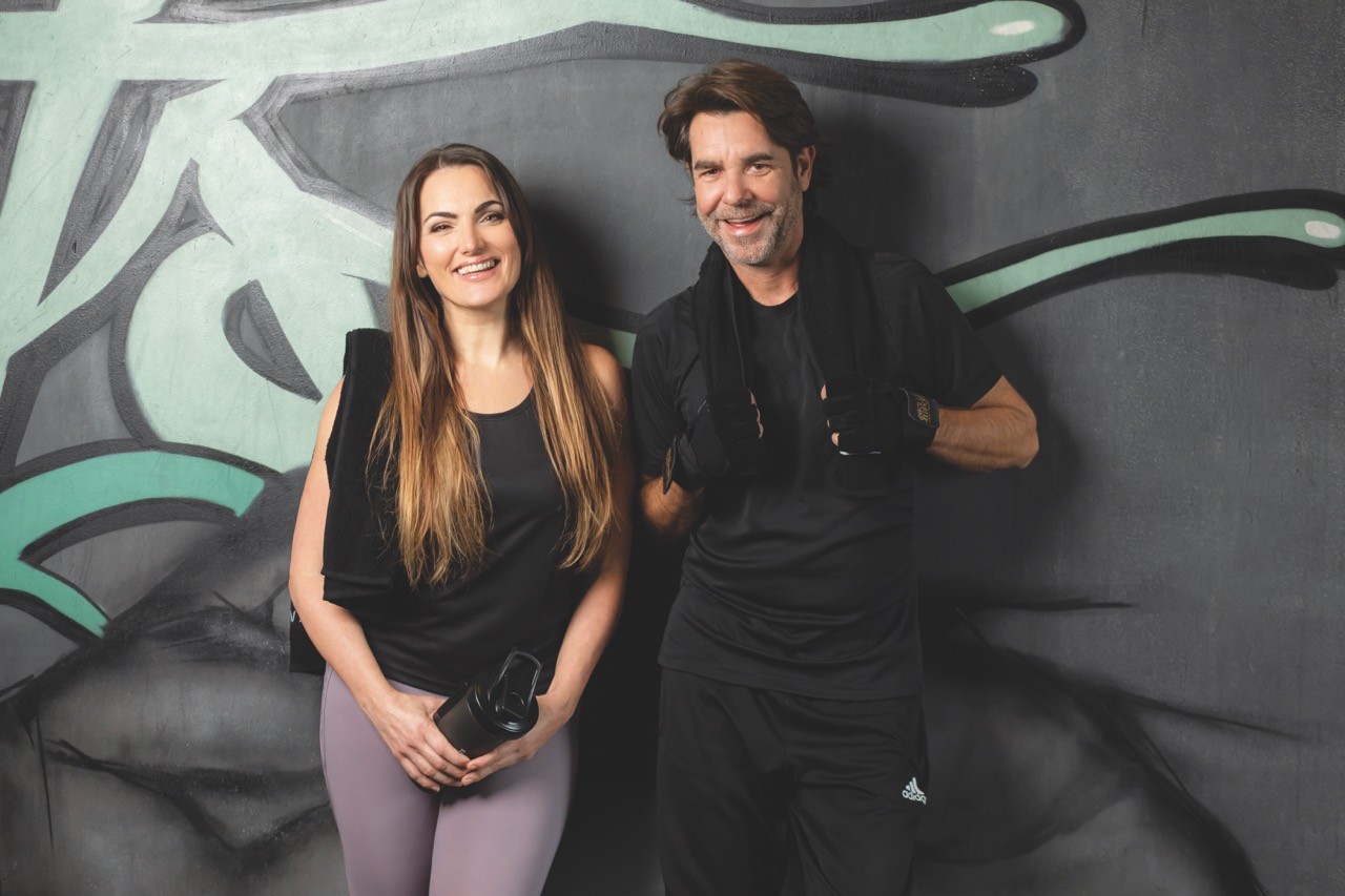 2 women in black tank top and leggings doing yoga
