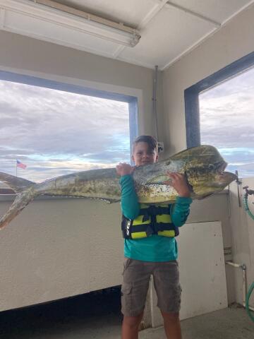 Boy holding Dolphin (Mahi Mahi)