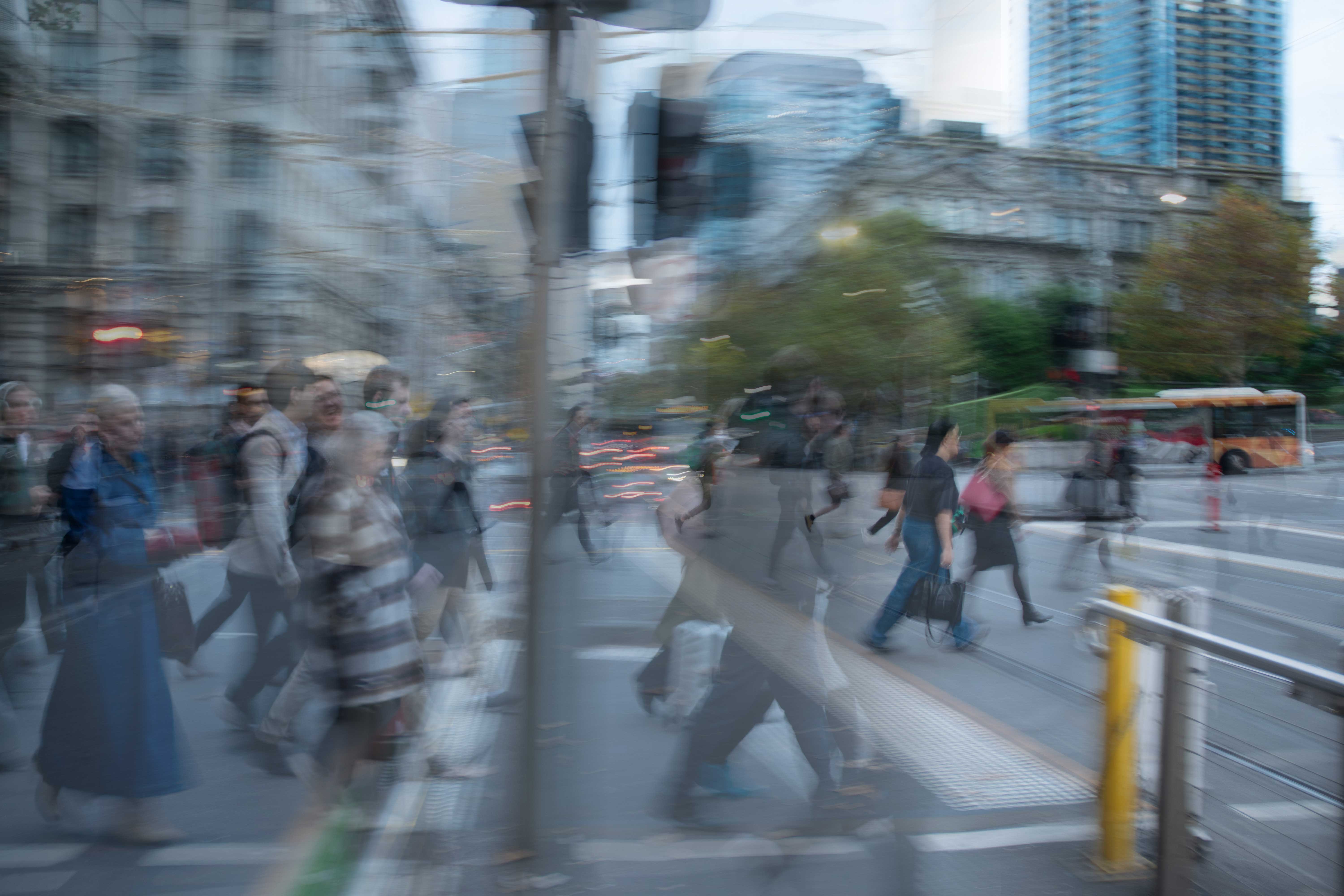 Photo of people walking in front of glass