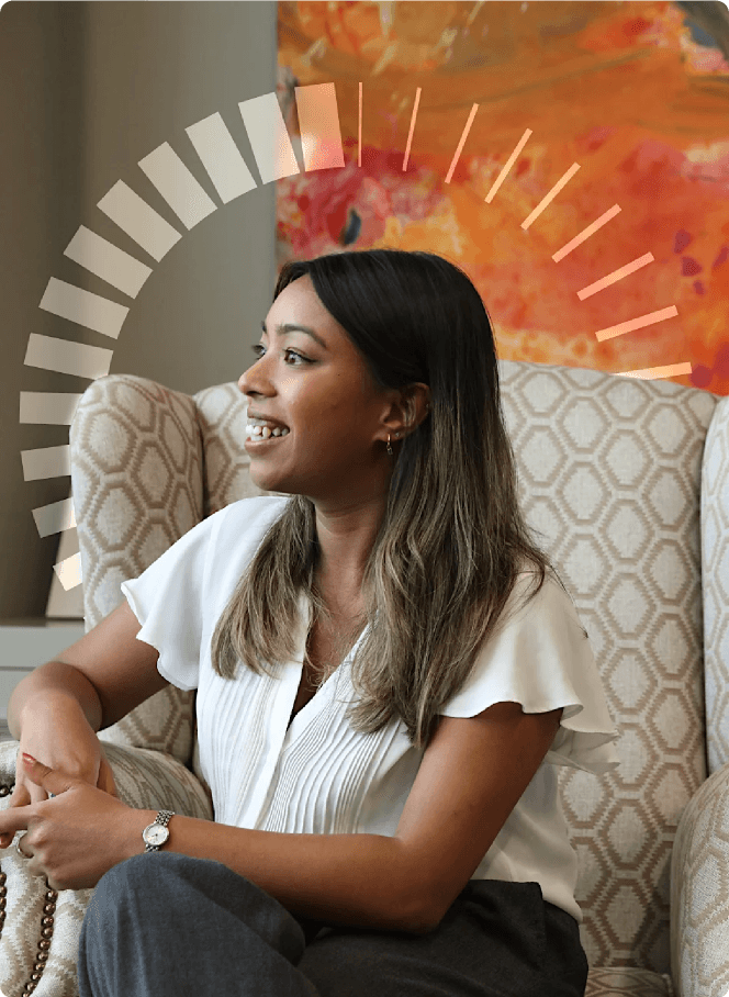 Smiling legal professional in conversation during a meeting, representing collaboration and confidence in a modern legal environment.