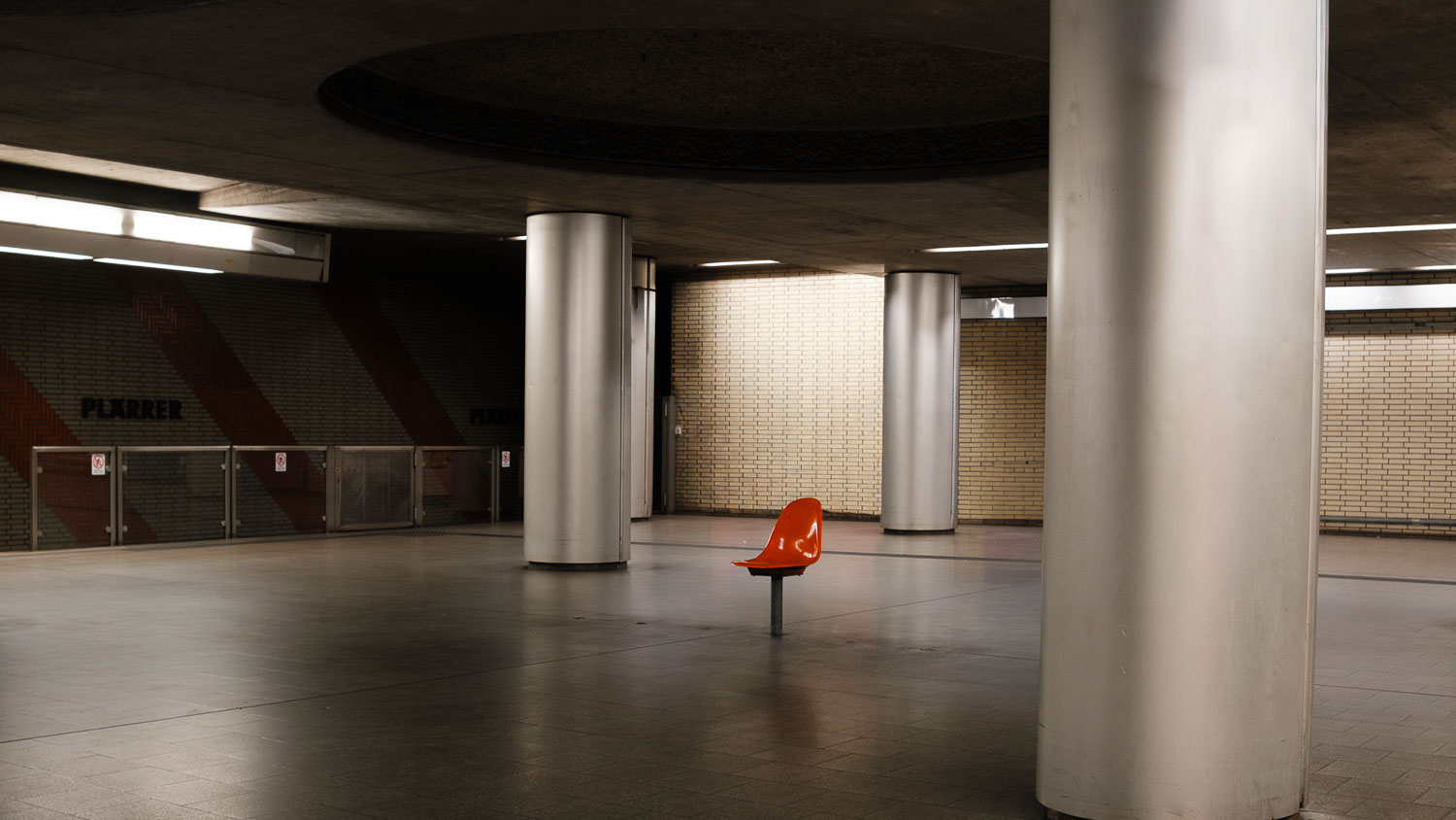 a single chair in a subway station