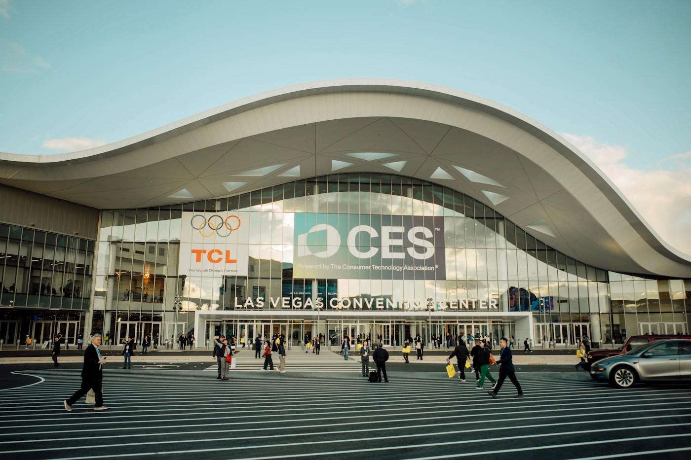 Las Vegas Convention Center entrance with CES branding and attendees crossing outside