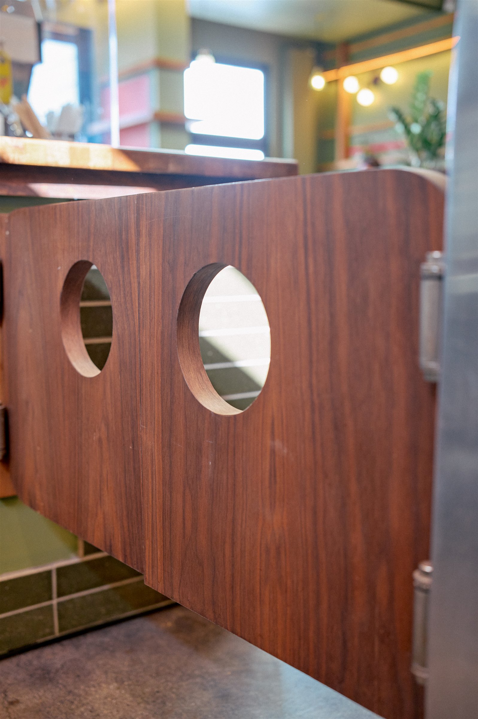 Timber swing doors with round portholes at the Dedo Coffee counter