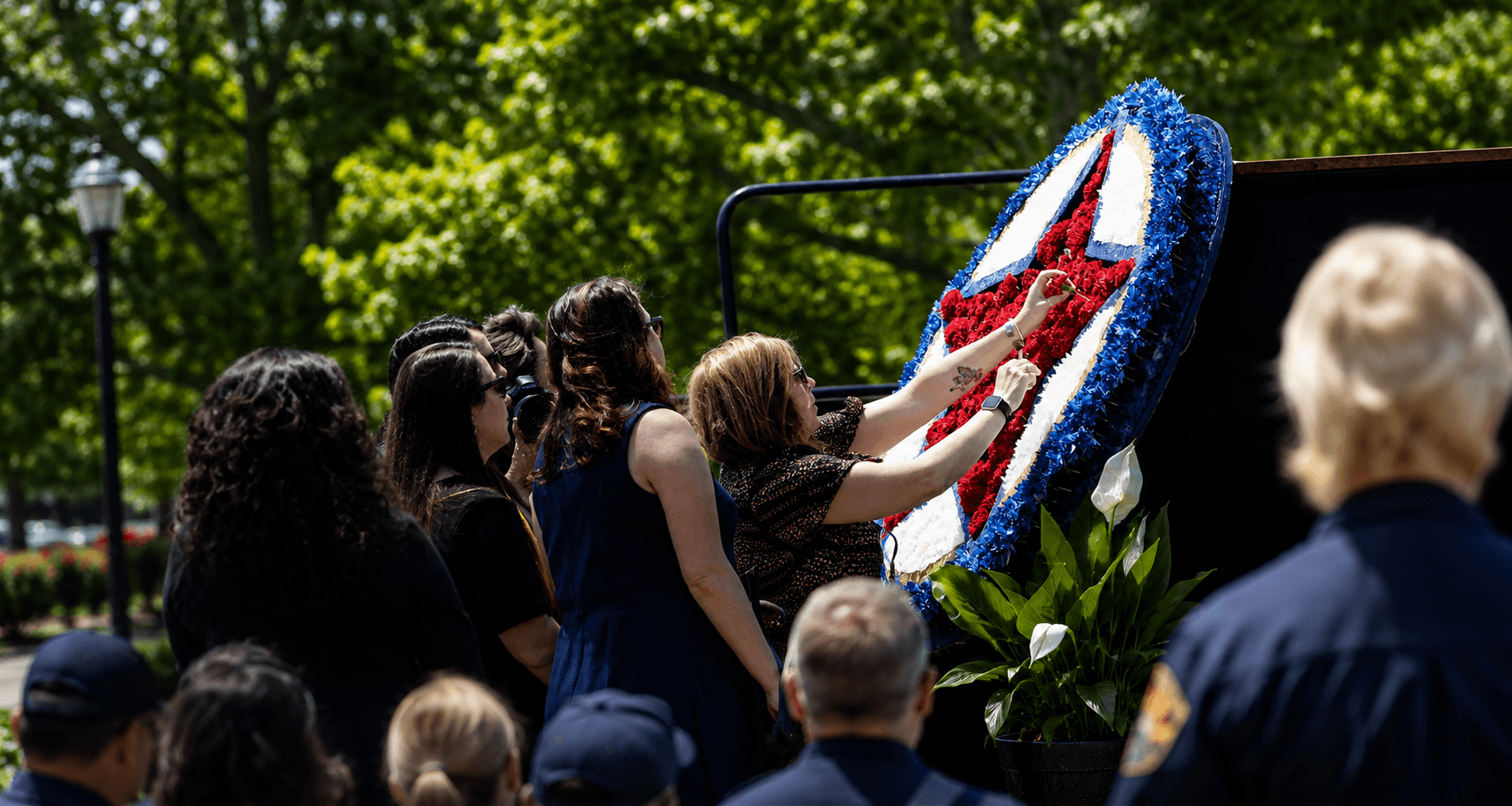 Woman placing rose onto memorial reef