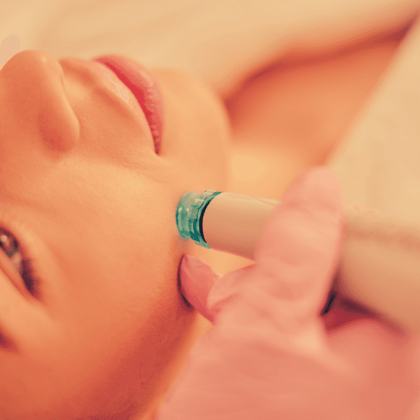 A woman receiving a hydrodermabrasion treatment