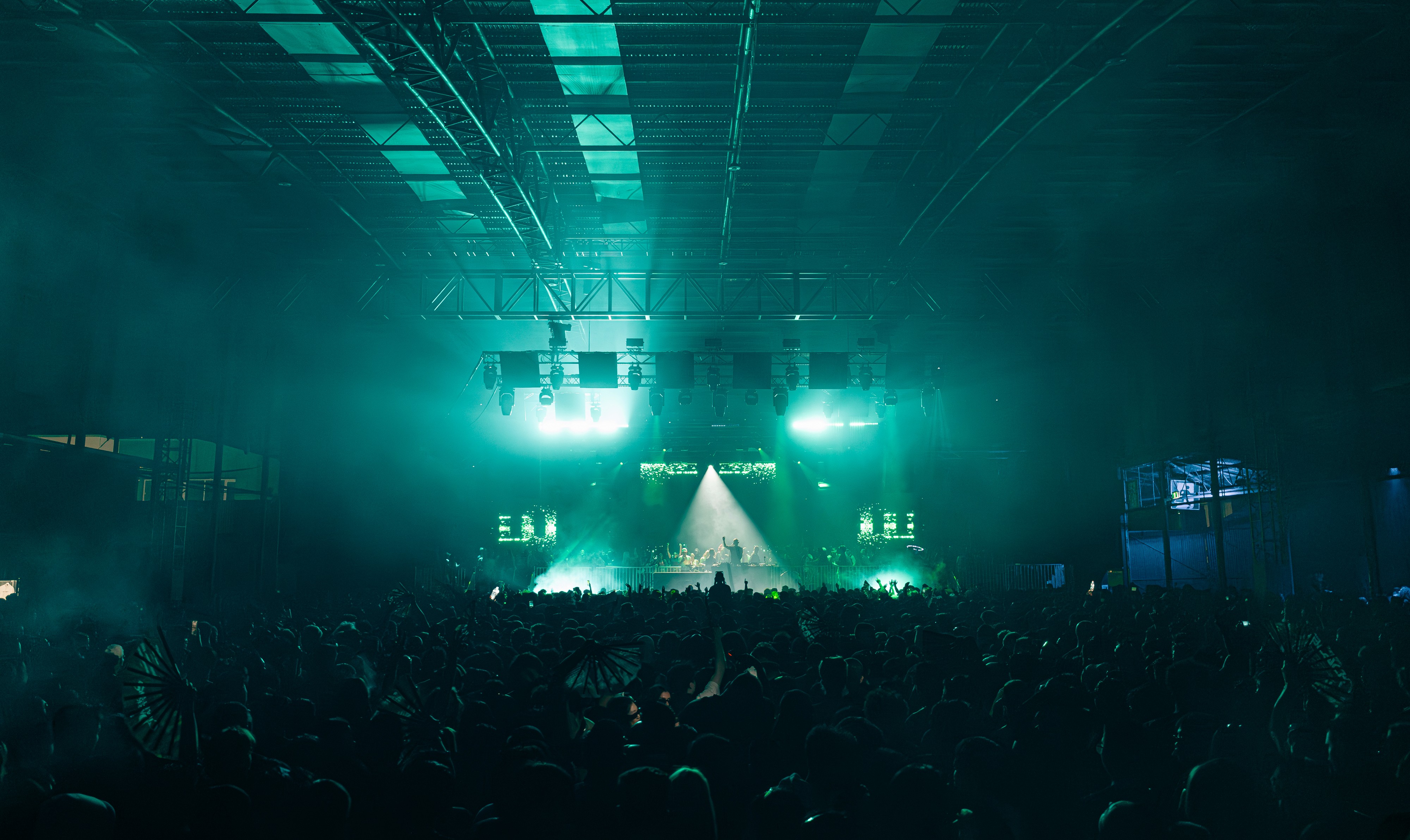 DJ playing to a large crowd at Paradigm Festival