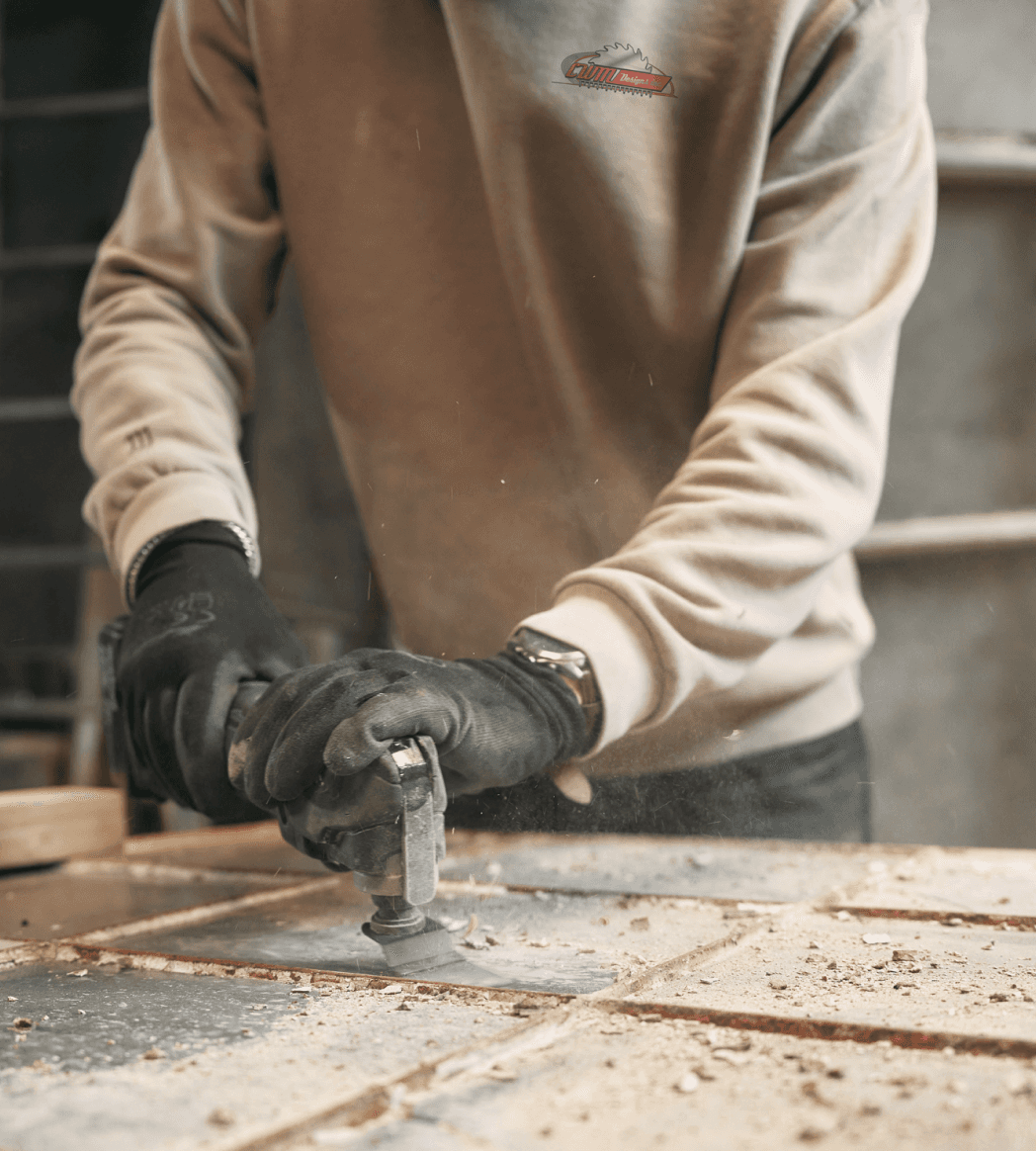 Contractor using power tools wearing a CWM sweatshirt
