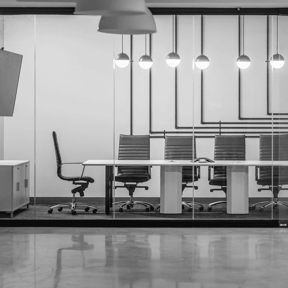 Minimalist office furniture setup showcasing premium executive task chairs with ribbed upholstery in a sleek, contemporary corporate meeting space.