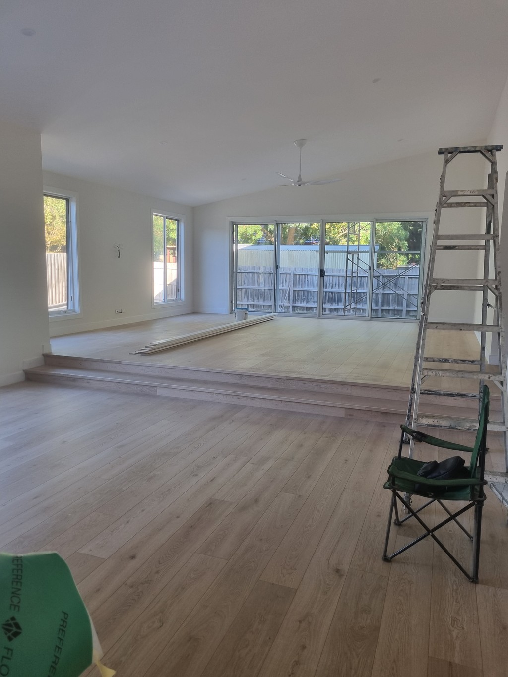 Spacious residential interior painting project with polished wooden flooring and freshly painted walls, enhancing the modern aesthetic and value of the home.