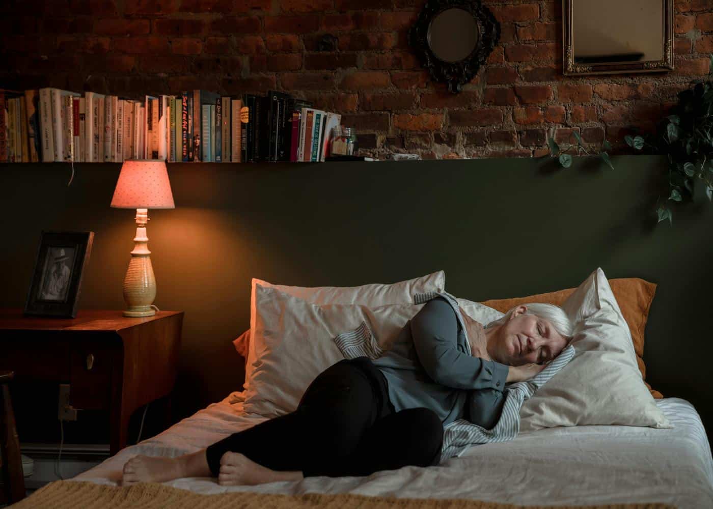Effective sleep hacks: woman in a deep sleep lying on a comfy bed