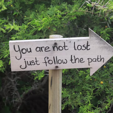 Wooden sign with inspirational message in the woods