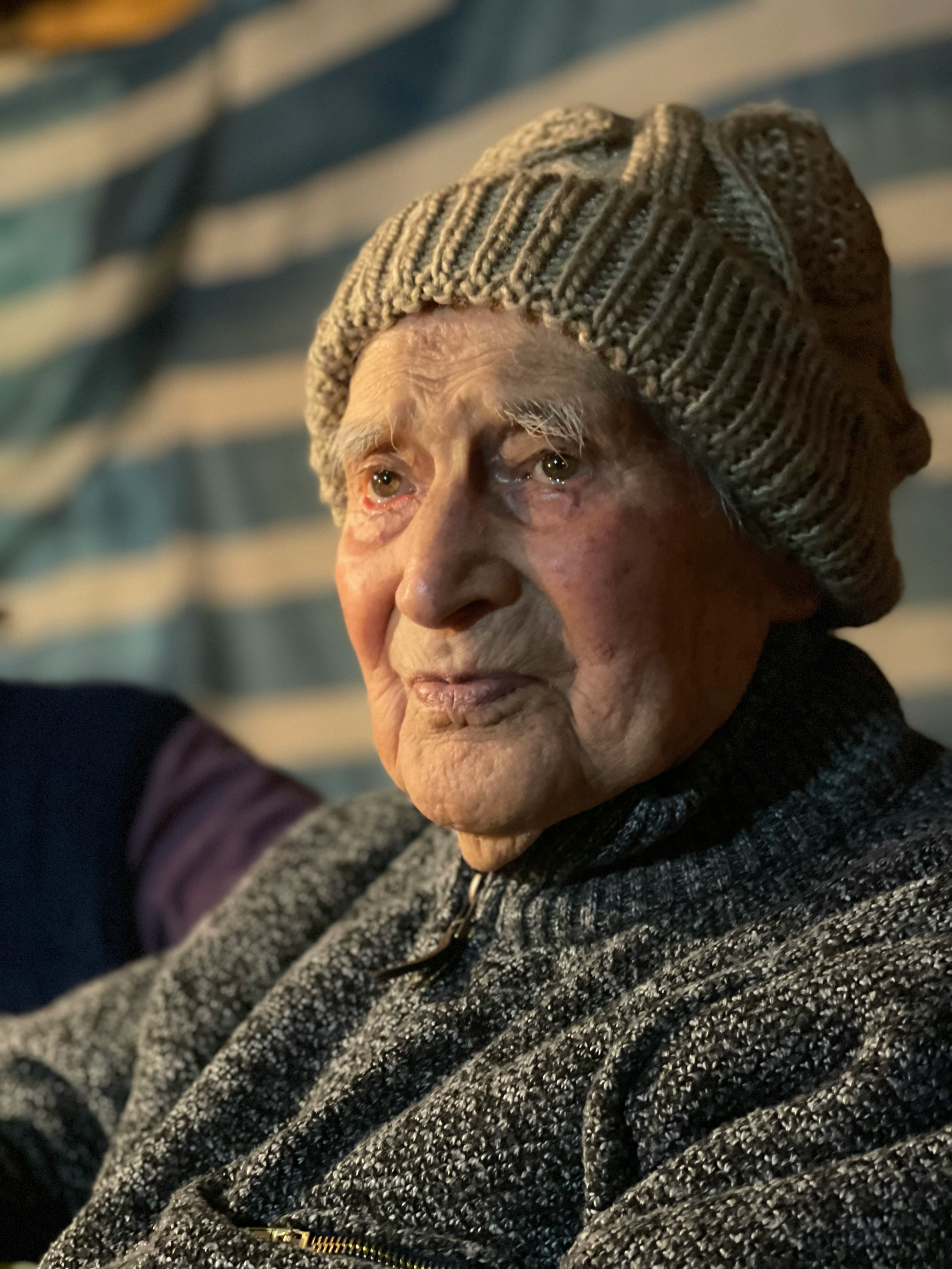 Elderly woman wearing a knitted hat and sweater