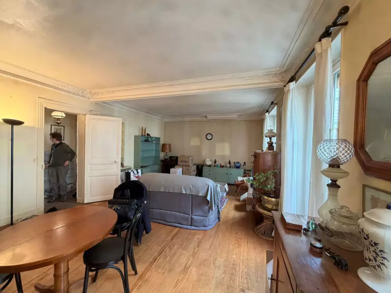 A serene backyard with a pool, sun loungers, and olive trees, set against a warm, sunny landscape.