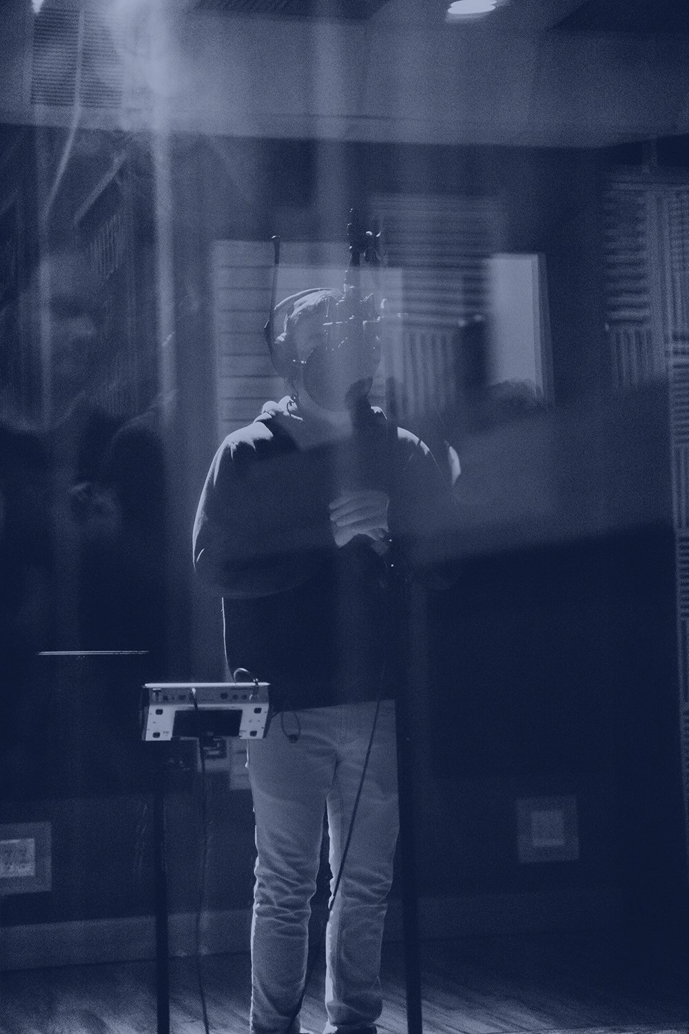 Surreal portrait of a man covering his face with blooming flowers, symbolic creative expression.