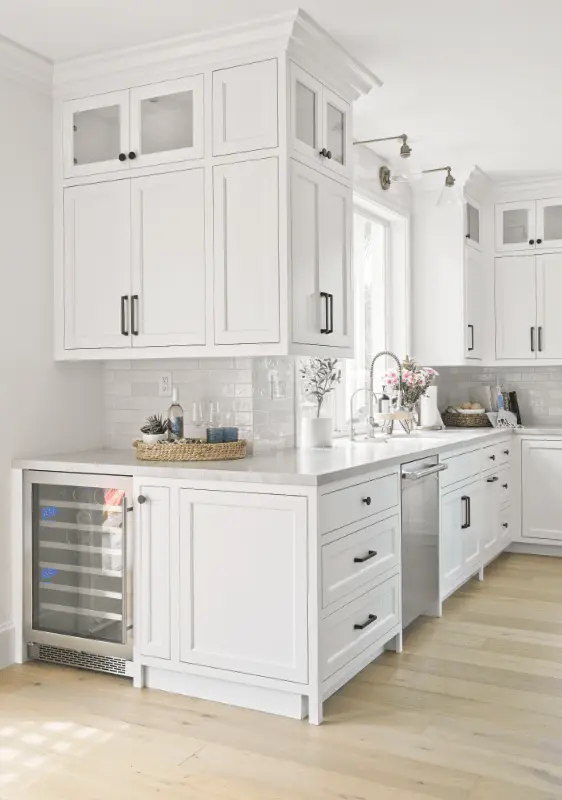 Portrait view of the kitchen sink wall, including the wine fridge, in the Dana Point Remodel. Photo by Todd Huge.
