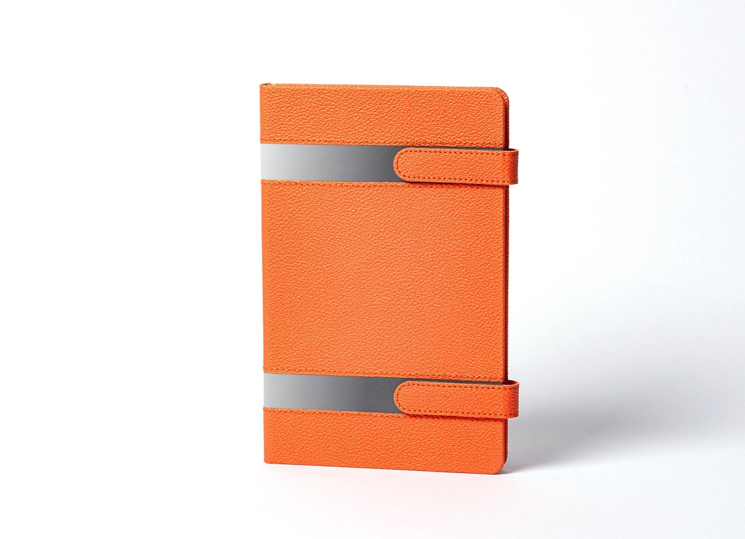 Front view of orange notebook with grey horizontal stripes.