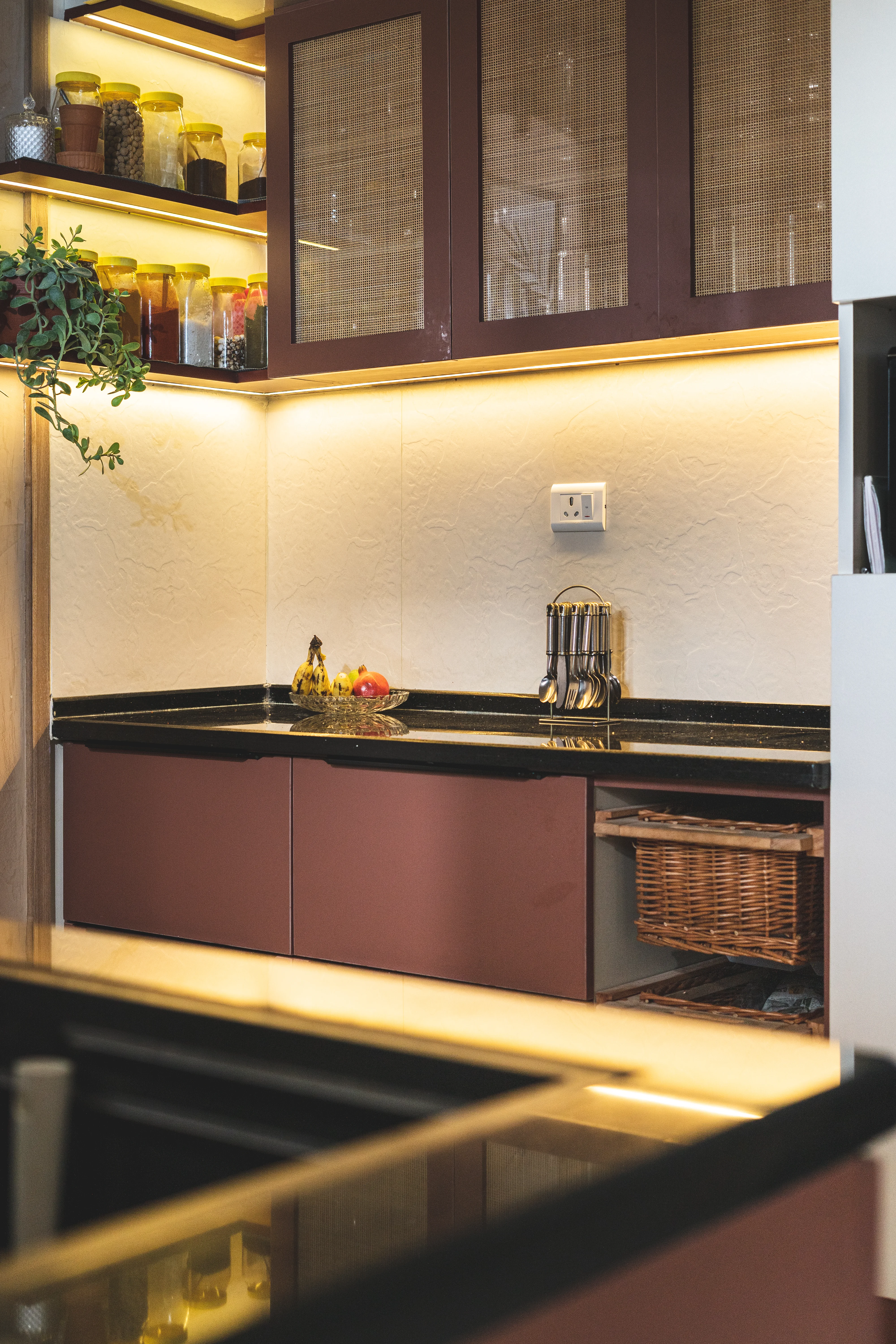 A modern kitchen featuring ambient lighting , sleek counter, and stylish cabinets, designed for South Indian homes.