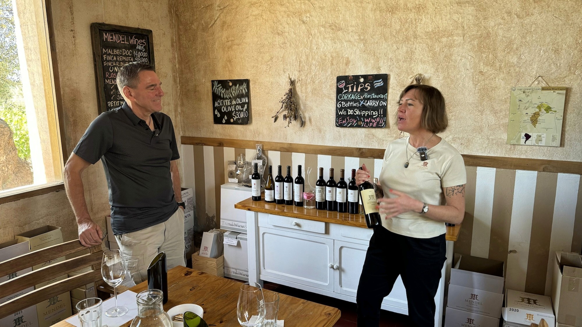 Mendel host Elena Drannikow presenting a bottle during a wine tasting at Bodegas Mendel in Mendoza