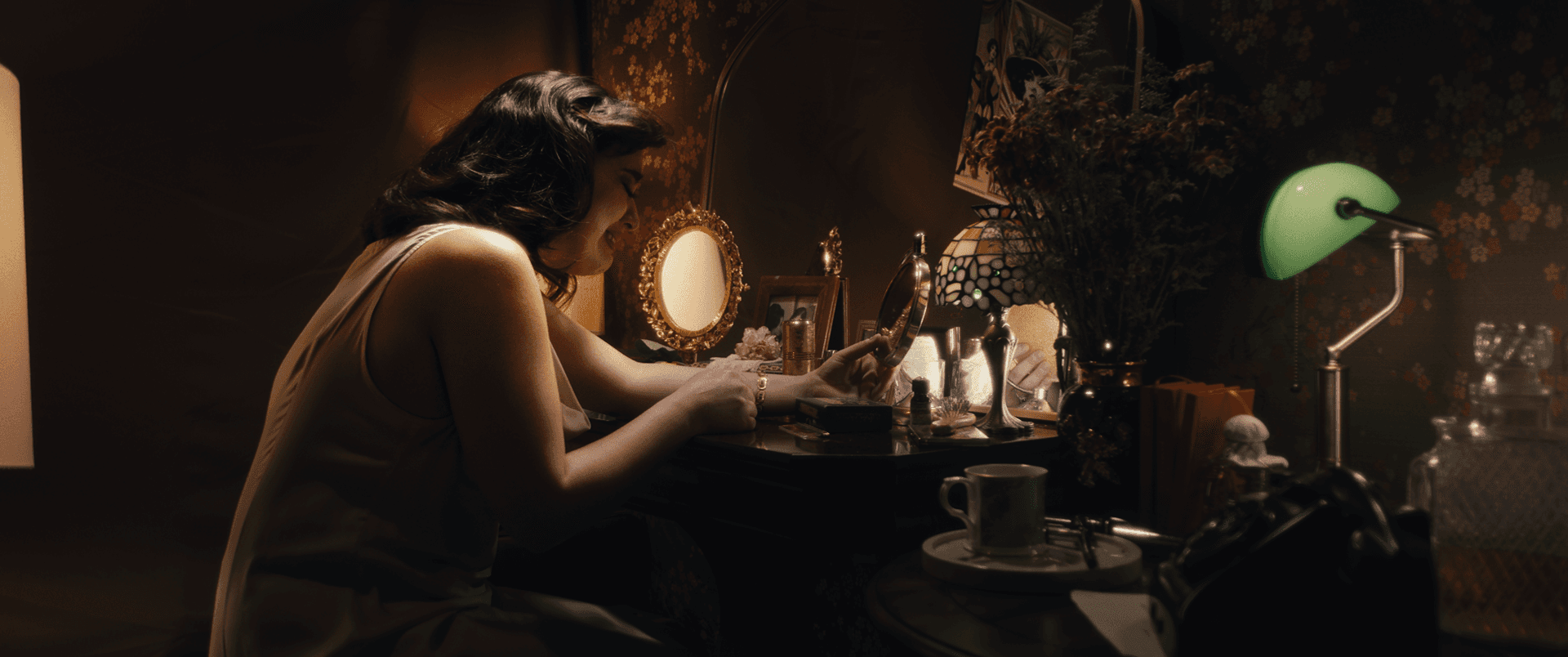 Cinematic still from the period short film 'Debora', featuring actress Pili Lara at a vintage dressing table. Photographed by Mexico City DP Mauricio Nader using a Blackmagic Pocket 6K G2 paired with vintage Leica R lenses to create a warm, nostalgic atmosphere.