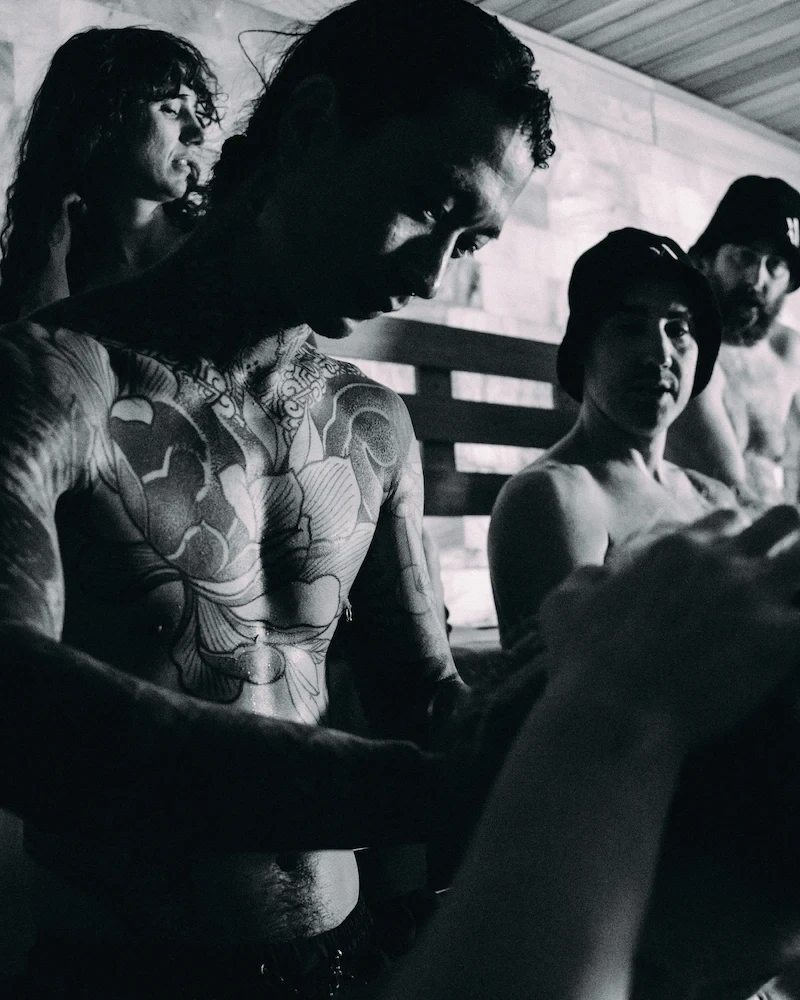 Guided Venik massage session in a communal sauna, where participants observe proper technique and steam room etiquette.