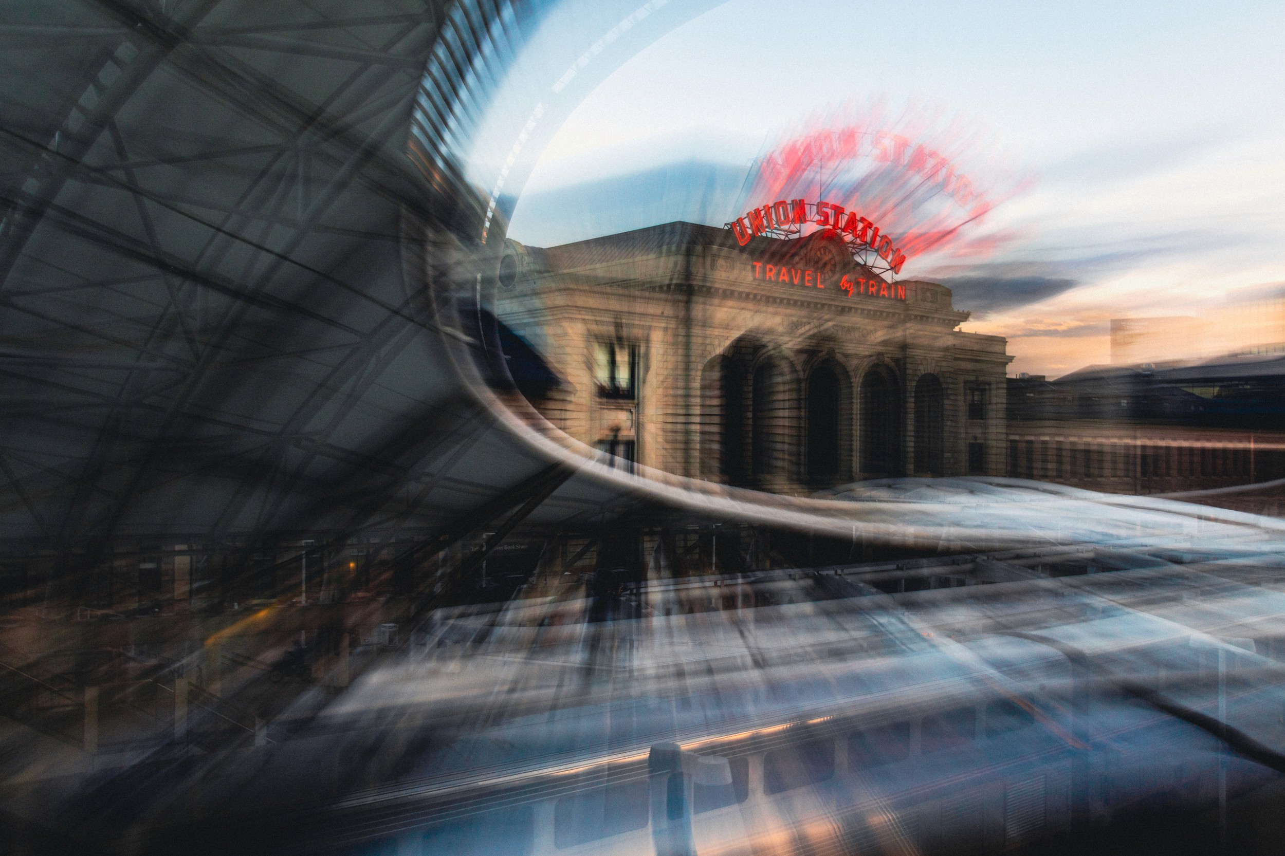 Denver’s Union Station framed in a circular zoom blur, evoking motion and disorientation