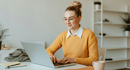 Client smiling while using a wealth management platform on her laptop
