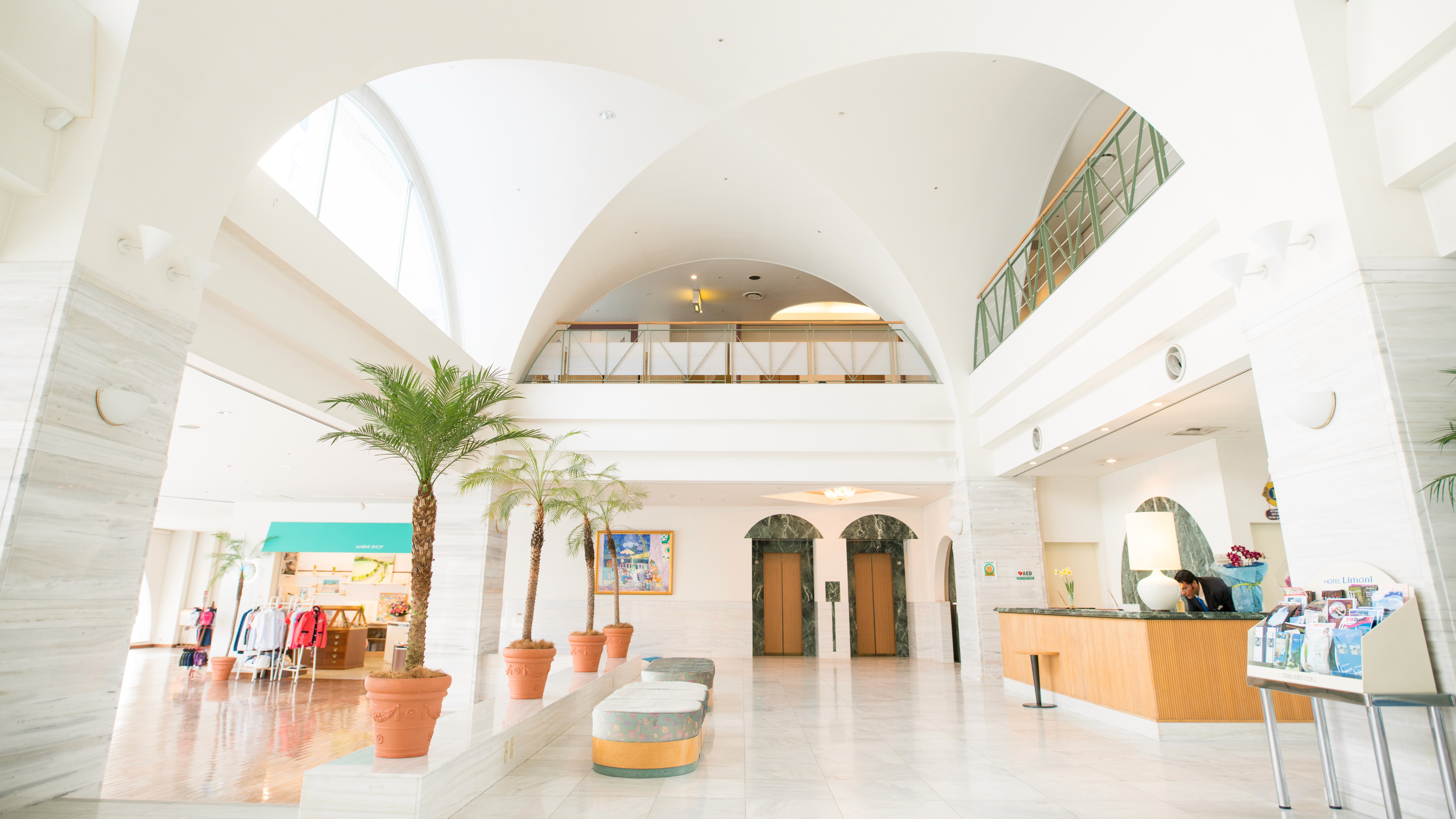 Interior of Hotel Limani's Greek inspired lobby with palm trees