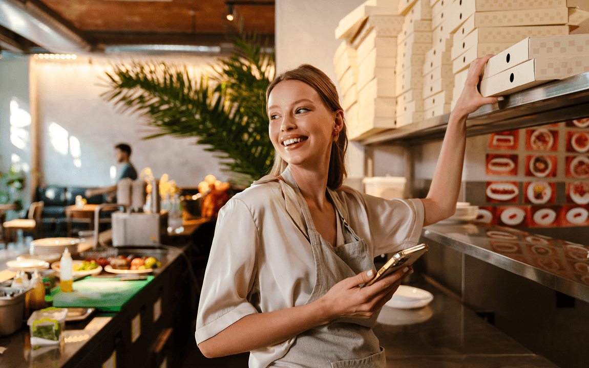 woman sitting while working on laptop and smiling