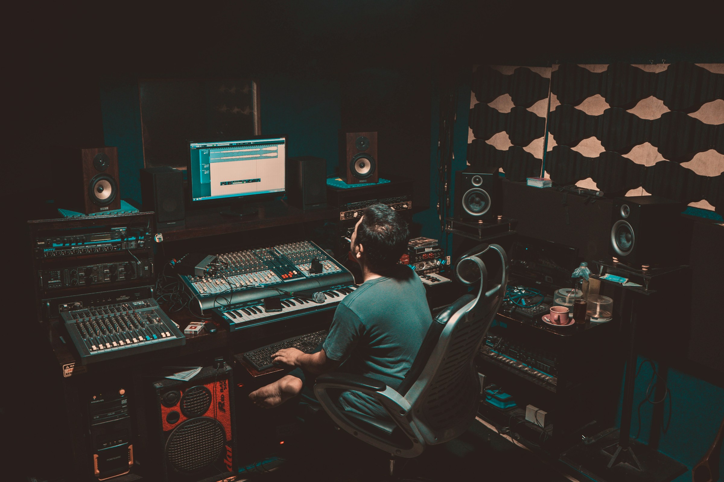 person in studio - Music Producer vs. Engineer