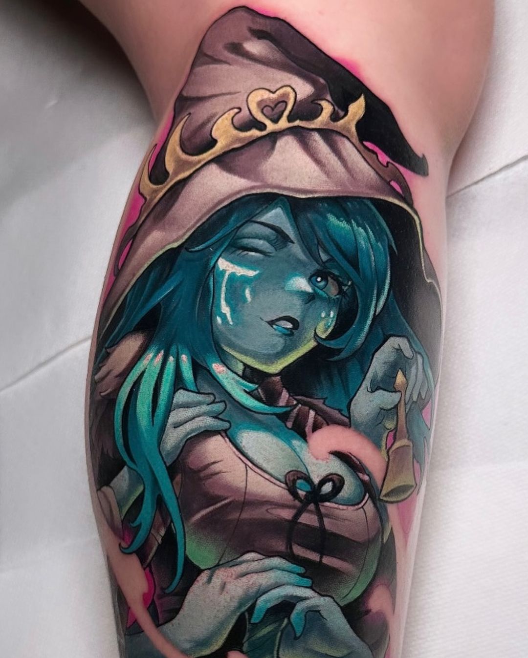 This tattoo features Ranni the Witch from Elden Ring, showcasing her blue hair and hooded cloak with a playful wink that captures her mysterious charm.