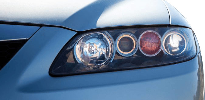 Detailed close-up of a Mazda headlight with surrounding body panels visible