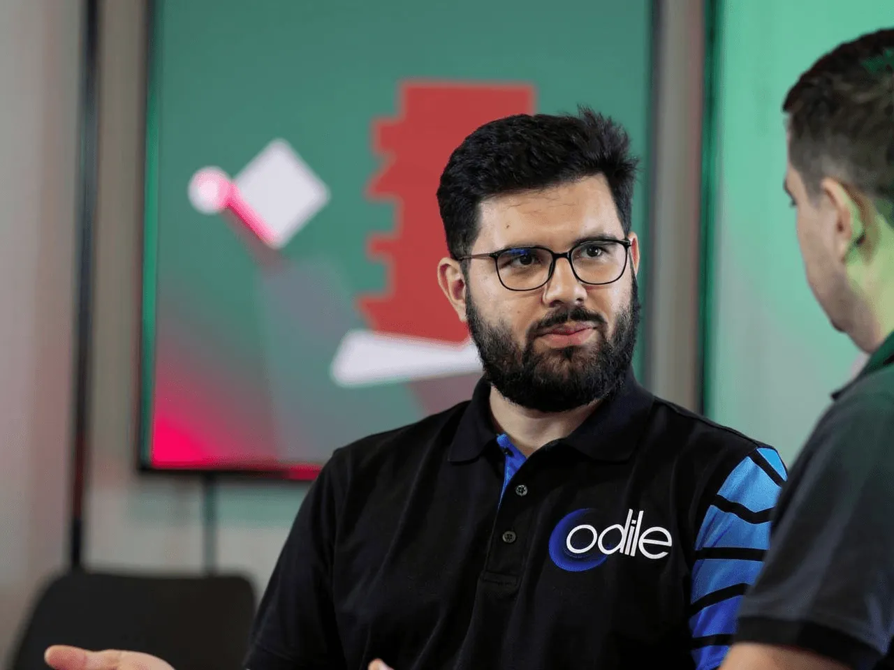 A group of men standing around each other in a room