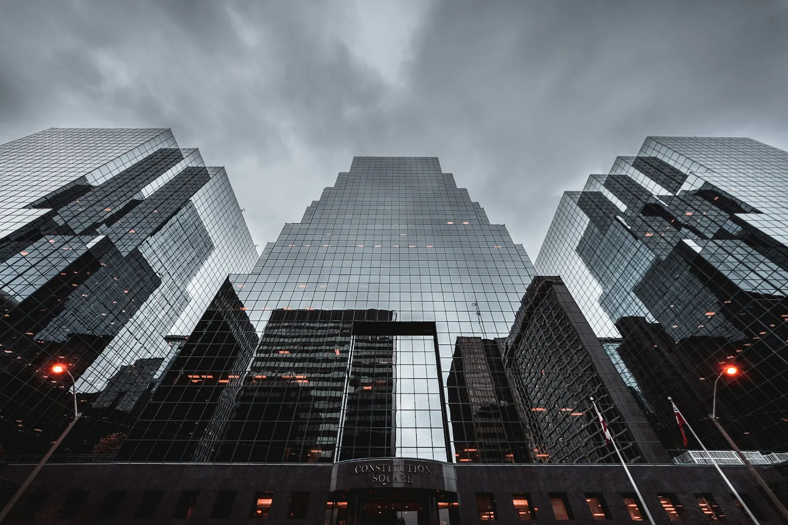 Glass office towers seen from below in black and white