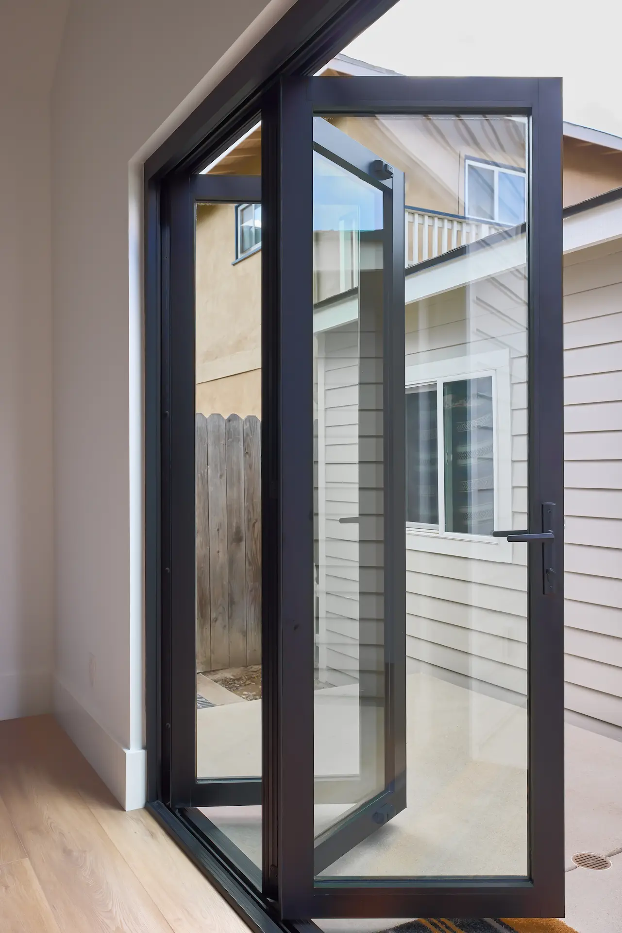 Portrait the bi-fold side entry door of the ADU remodel, which is a contemporary upgrade to the Craftsman style structure. Photo by Todd Huge.