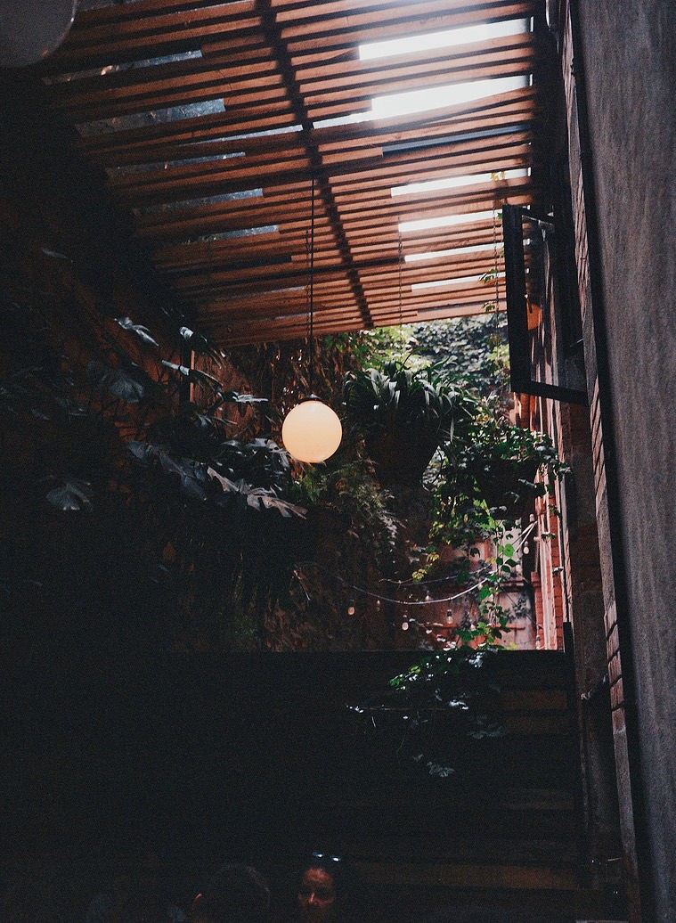 A tall waterfall cascades into a turquoise pool below.