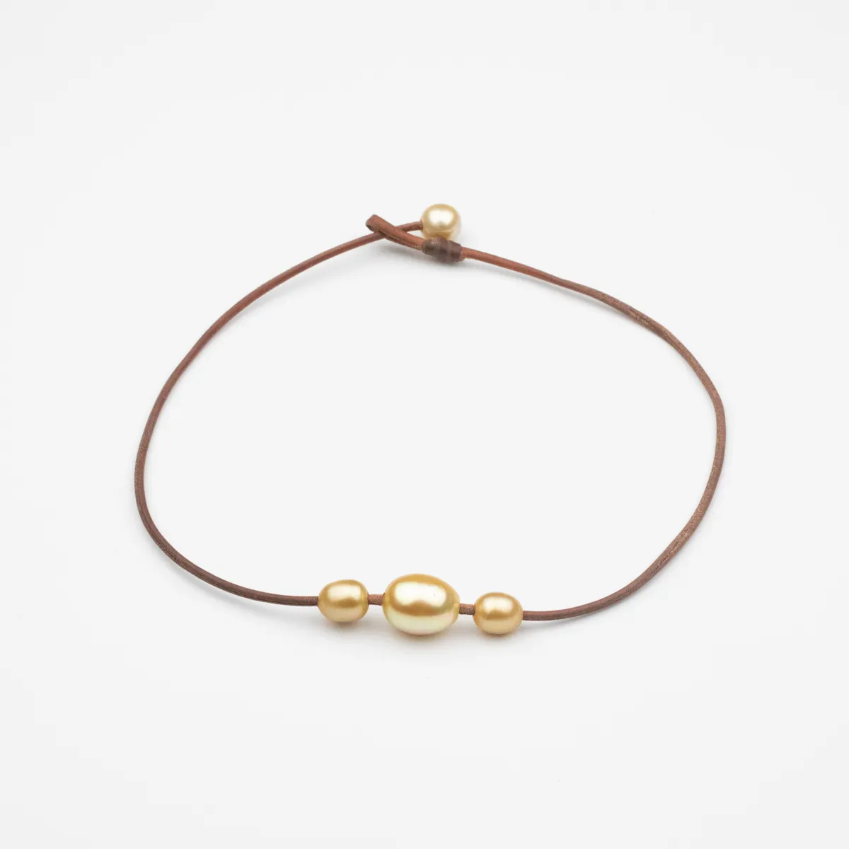 Golden South Sea Pearl leather necklace with four baroque pearls and pearl toggle closure on natural brown leather cord — Manos de Oro Saint Barth