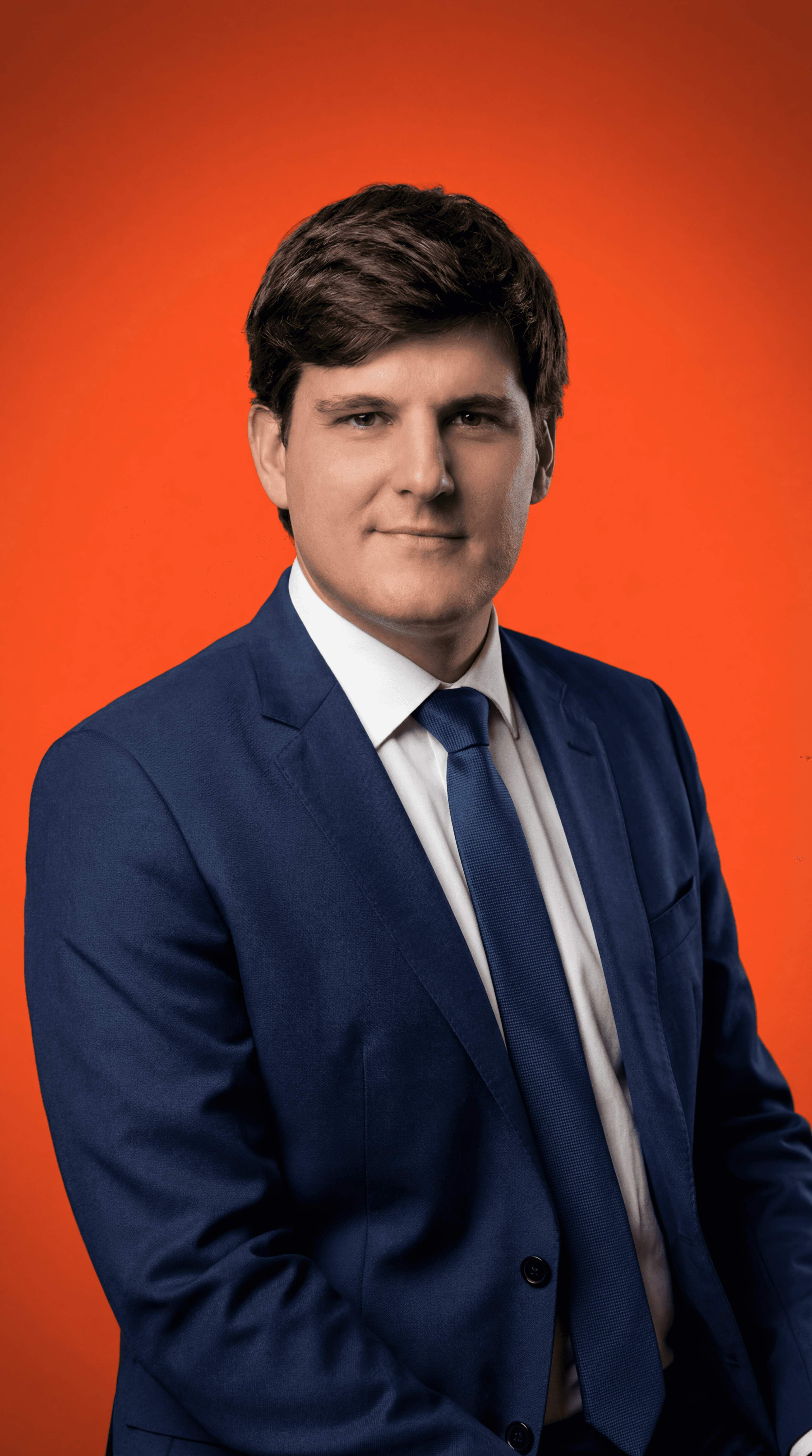 Smiling young Asian woman with long black hair, wearing a brown turtleneck against a neutral gray background. Warm and approachable vibe.